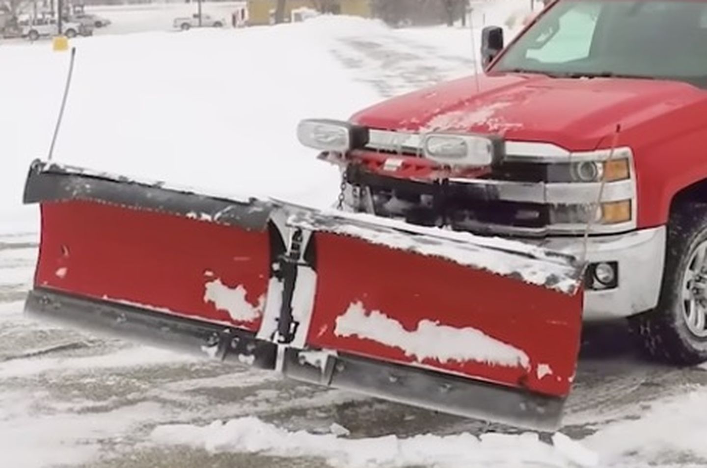 B&G plow truck clearing a commercial lot